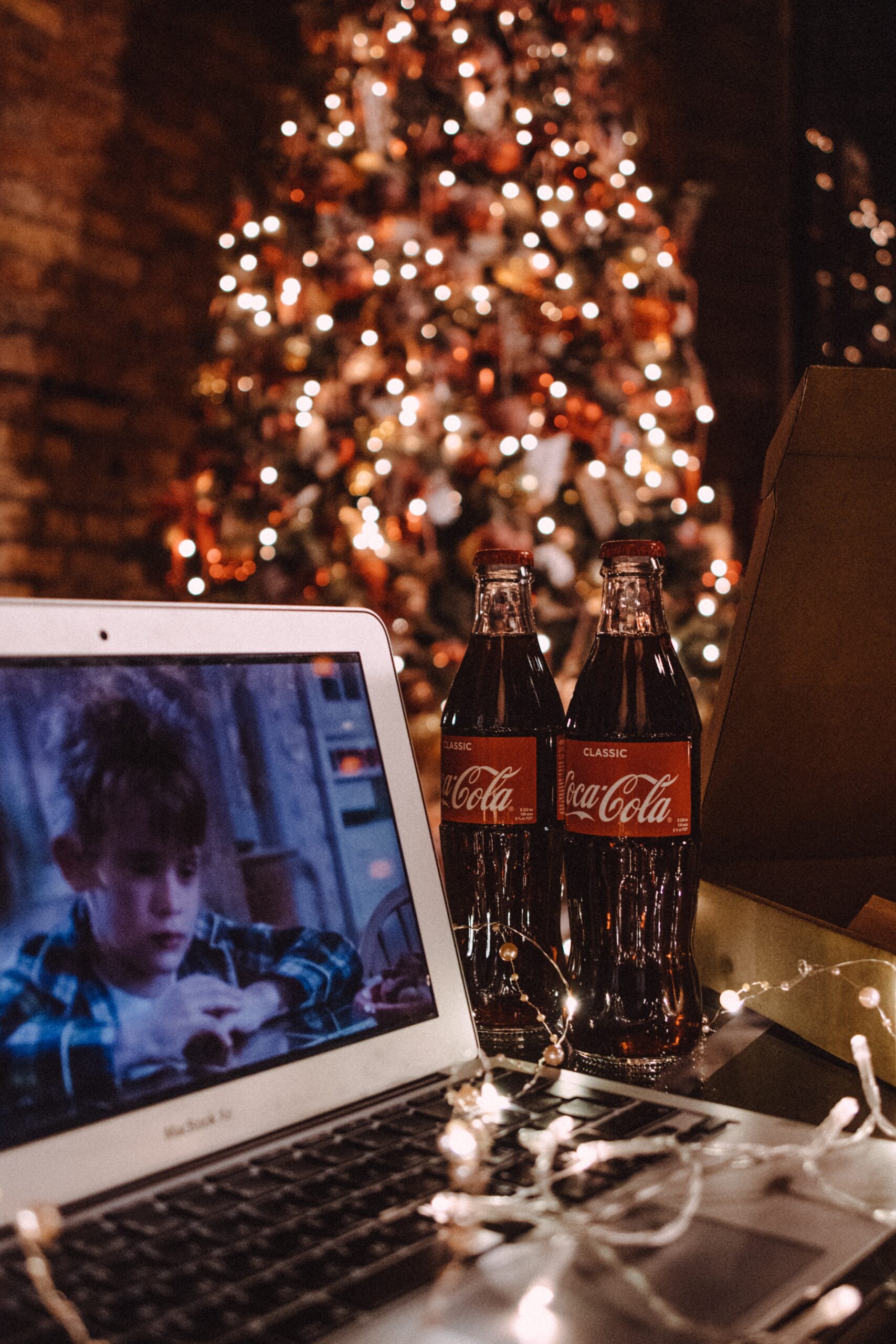 coca cola bottle beside white ipad